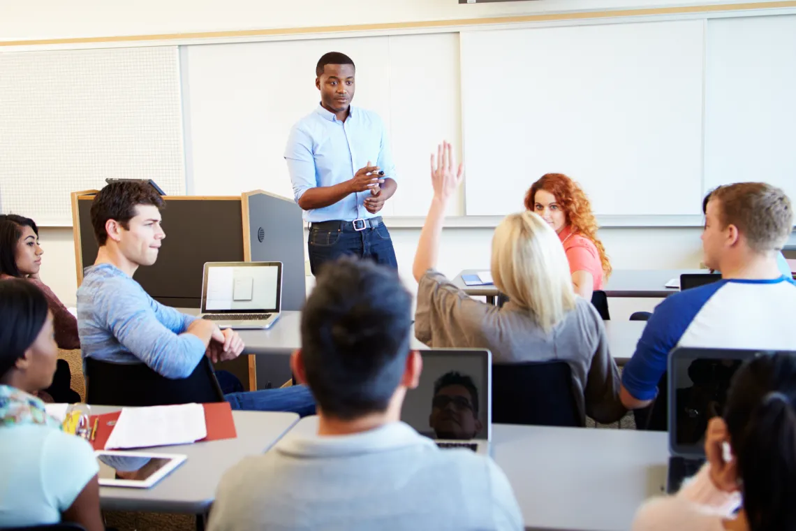 Student raising their hand in class